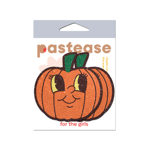 Pumpkin Breast Pasties Cutie Pie Face Jack O Lantern Nipple Covers by Pastease. These glittery pumpkin nipple covers have cute cartoon smiling faces with big eyes shown in their pastease packet on a white background.