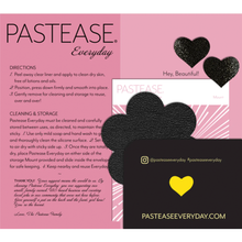 Load image into Gallery viewer, Everyday Reusable: Onyx Flat Black Suede Flower with Mini Hearts Reusable Nipple Pasties by Pastease® Everyday on a pink background with a thank you message. Perfect for a festival, pride, burlesque performance, only fans content or a party.
