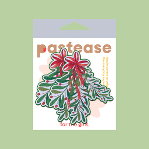 Christmas Winter Mistletoe with Red Bow Kissing Nipple Pasties by Pastease®. Two glittery mistletoe nipple covers, shown on green background. Perfect for a festival, burlesque performance, Christmas, pride or parties.