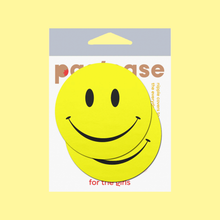 Load image into Gallery viewer, Smiley Faces: Bright Yellow Nipple Pasties by Pastease®. Two yellow smiley face nipple covers, shown on yellow background. Perfect for a festival, burlesque performance, pride or parties.
