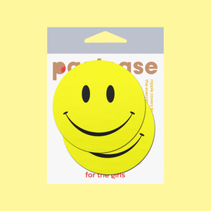 Smiley Faces: Bright Yellow Nipple Pasties by Pastease®. Two yellow smiley face nipple covers, shown on yellow background. Perfect for a festival, burlesque performance, pride or parties.