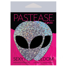 Load image into Gallery viewer, Alien: Silver Glitter Alien with Spacey Black Eyes Nipple Pasties by Pastease® o/s. Two silver holographic alien nipple covers in the pastease pink and black packaging on a white background. Perfect for a festival, pride, burlesque performance, only fans content or a party.
