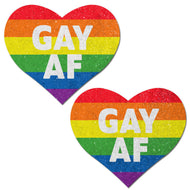 Love: Rainbow GAY AF on Glitter Velvet Heart Nipple Pasties by Pastease. Two rainbow stripe velvet heart shape nipple covers with white bold text that says GAY AF with all over glitter. Perfect for a festival, pride, burlesque performance, only fans content or a party.