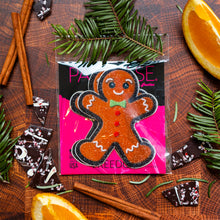 Load image into Gallery viewer, Gingerbread Man Woman Christmas Holiday Nipple Pasties by Pastease® o/s. Two gingerbread man shaped nipple covers on a brown flat lay background with cinnamon sticks, oranges, chocolate and fir tree branches. Perfect for a festival, pride, burlesque performance, only fans content or a party.

