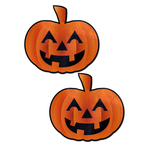 Pumpkin: Spooky Halloween Jack O' Lantern Nipple Pasties by Pastease. Two orange smiling carved pumpkins nipple covers on a plain white background. Perfect for a festival, pride, burlesque performance, only fans content or a party.