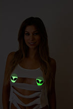 Load image into Gallery viewer, Alien: Neon/Green Glow in the Dark Alien Face by Pastease® o/s. Smiley long haired model wearing Two alien shaped nipple covers with glittery black eyes on white background. Perfect for a festival, pride, burlesque performance, only fans content or a party.
