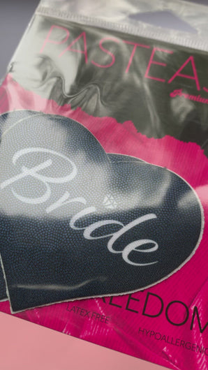Video of the Love: Black 'Bride' Heart Nipple Pasties by Pastease in the pink and black pastease packaging. 