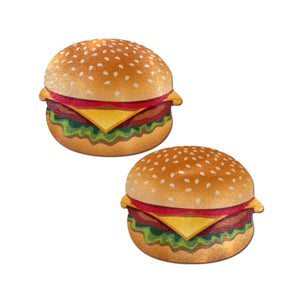 The Burger: Delicious Cheeseburger Nipple Pasties by Pastease. Two Cheeseburger nipple covers on a white background. Perfect for a festival, pride, burlesque performance, only fans content or a party.