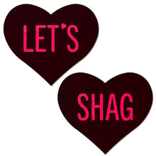 Load image into Gallery viewer, Love: Black Heart with Pink &#39;Let&#39;s Shag&#39; Nipple Pasties by Pastease. Two black hearts that say let&#39;s shag in pink text nipple covers on a white background. Perfect for a festival, pride, burlesque performance, only fans content or a party.
