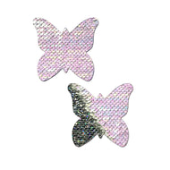 Monarch: J. Valentine® Pearl to Silver Flip Sequin Butterfly Nipple Pasties by Pastease®. Two pastel pearl pink and silver holographic sequin monarch butterfly nipple covers on a white background. Perfect for a festival, pride, burlesque performance, only fans content or a party.