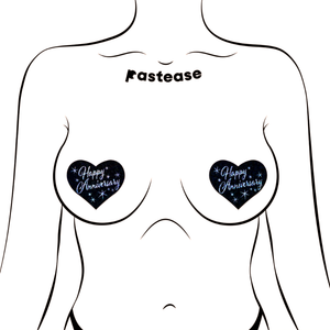 Love: Happy Anniversary Heart Pasties by Pastease®. Two glittery black heart shaped nipple covers with silver italic font reading happy anniversary and stars shown on a femme body outline for size reference on a white background.